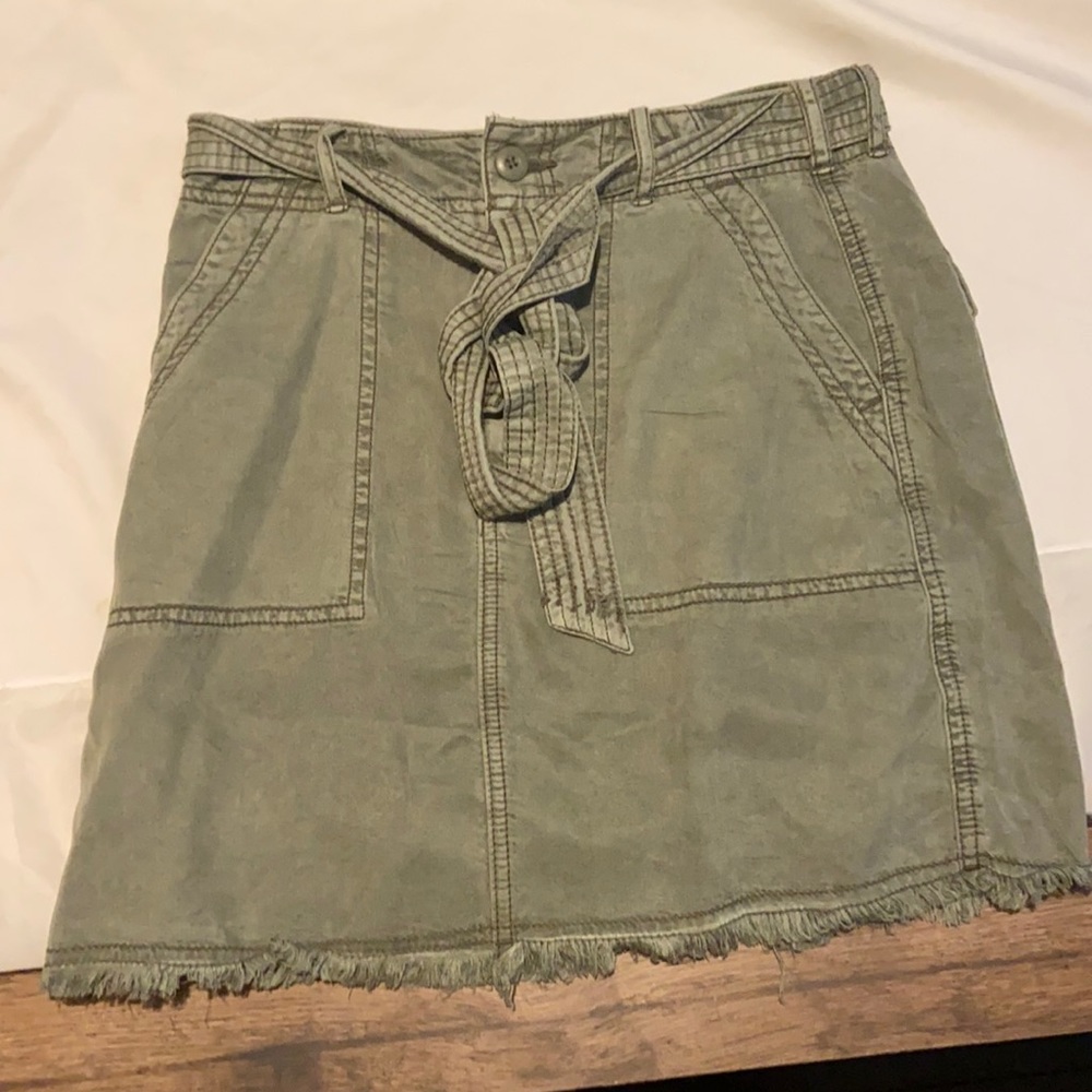 green skirt with button and tie belt